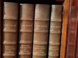 many books that are on a shelf in a library