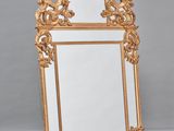 an image of a gold mirror sitting on top of a checkered floor