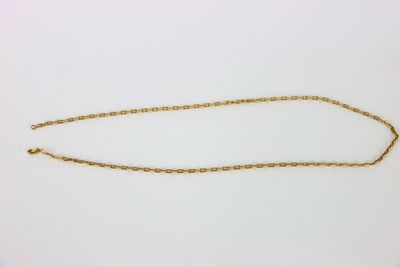 a gold chain that has been placed on a white surface