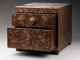 a small wooden box with two drawers on it