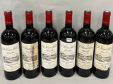 six bottles of red wine lined up in a row on a table