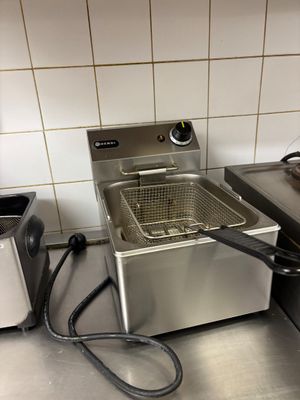 a deep fryer sitting on a counter in a kitchen