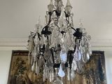 a chandelier hanging from the ceiling in a living room