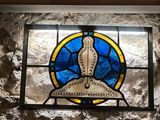 a stained glass window with a bird on it