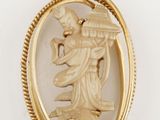 an image of a gold pendant with an image of a woman holding a basket