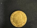 a close up of a gold coin on a black cloth