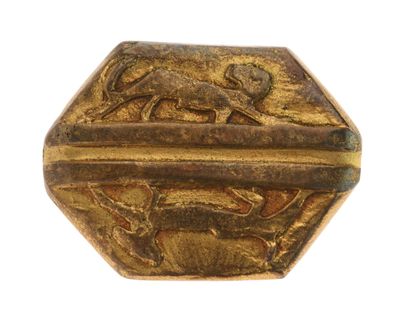a close up of a gold object on a white surface