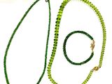 green beaded necklace and bracelet set on a white background