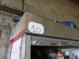 an image of a stainless steel refrigerator with a sign on it