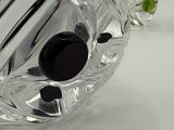 a close up of a glass vase with a black object in it