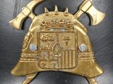 a gold helmet with two axes on top of it