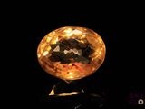an image of a golden colored diamond on a black surface