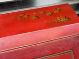 a red box with gold flowers painted on it