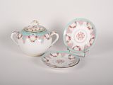 three pieces of porcelain teapot and saucer on a white background