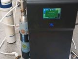 a machine that is sitting on a counter next to some water