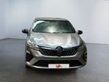 the front view of a silver car in a showroom