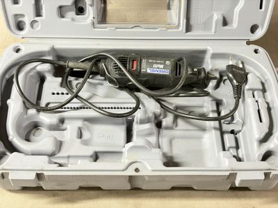 a tool in a plastic case with wires in it