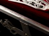 a silver knife sitting on top of a red velvet case