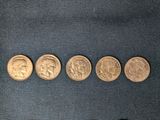 a close up of a row of coins on a blue cloth