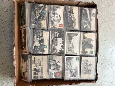 a cardboard box with a bunch of old photos in it