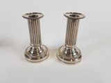 pair of silver candlesticks on a white background