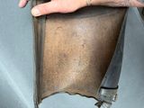 a person holding a piece of leather in their hand