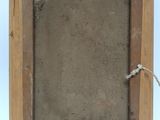 an old wooden picture frame with a rope hanging from it ' s side