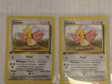 two pokemon cards are sitting on top of each other on a table