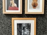 three framed pictures of a woman sitting on a couch next to a toilet