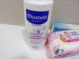a bottle of lotion, toothpaste, and baby wipes on a counter