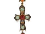 an image of a cross made out of glass with a red and green stone in the center