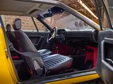 a yellow car with black seats and a red seat belt