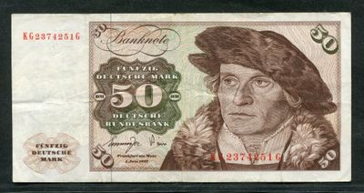 un gros plan d'un billet de banque sur lequel figure le portrait d'un homme