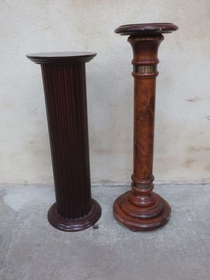 two tall wooden candlesticks sitting next to each other