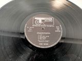 a black record with a label on it on a table