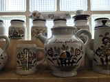 many vases that have been painted on the counter