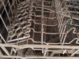 a close up of a dishwasher with many dishes in it