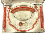 an orange beaded necklace and bracelet set in a silver box