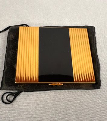 a black and gold case sitting on top of a black bag