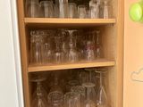 a cabinet with a lot of empty glasses on it