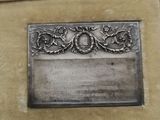a silver plaque in a case on a table