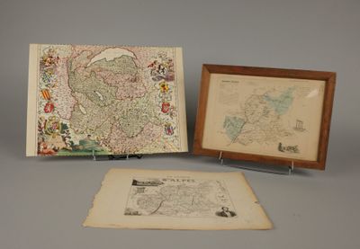two framed maps and a picture of a map on a table