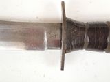 a close up of a knife on a white surface
