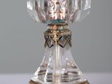 a glass vase with a gold and silver decoration on it