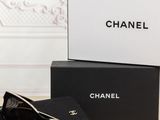 chanel sunglasses on a table next to a black box