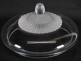 a glass plate with a glass lid on a black background