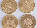 four different types of gold coins on a white surface