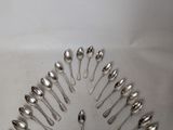 a lot of spoons arranged in a circle on the table