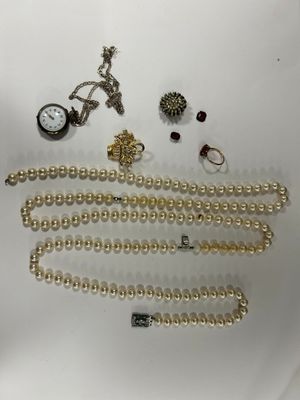 a lot of jewelry on a white surface