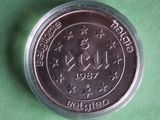 a close up of a silver coin on a green surface
